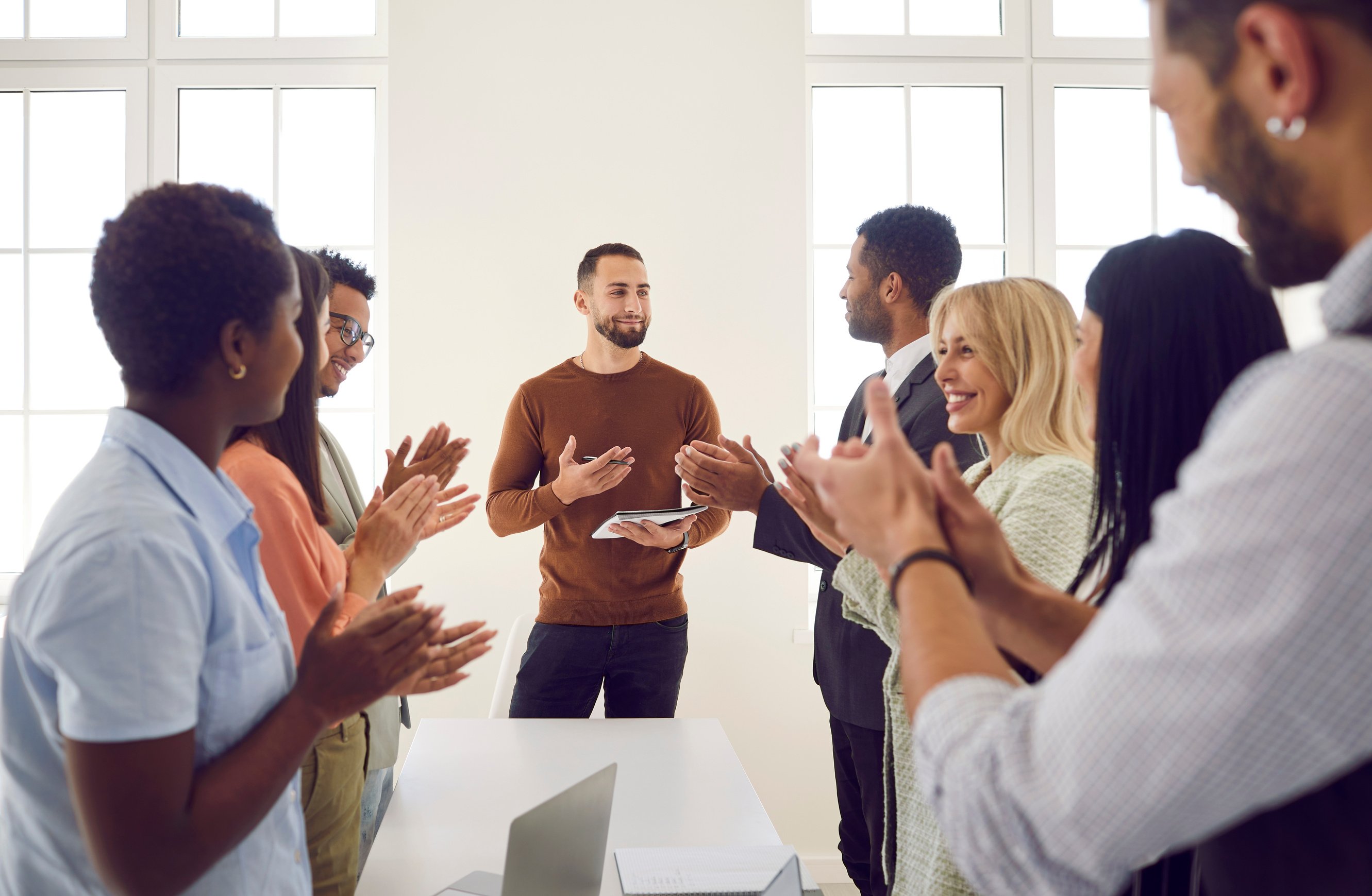 Happy Employees Applaud Thanking Speaker for Presentation